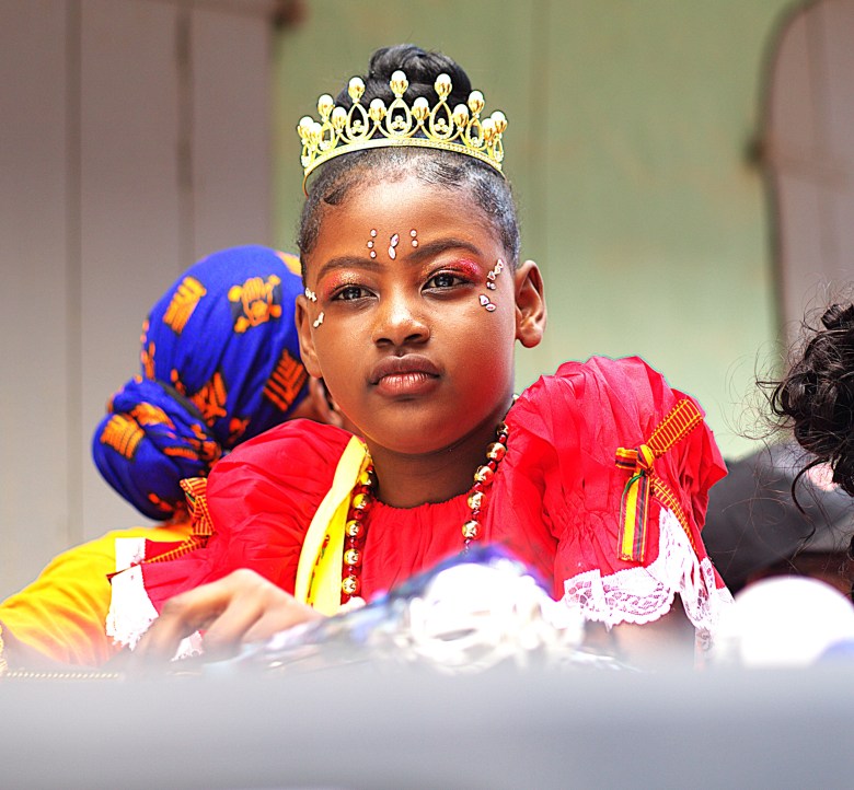 A princess from the back of a pickup truck. Photo by Onz Chéry/ The Haitian Times