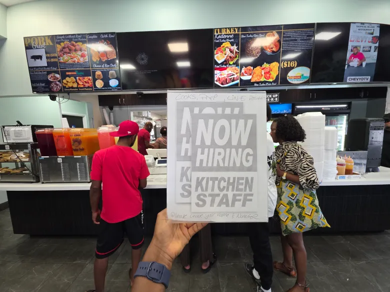 A“Now Hiring” signage at Tropical Island Restaurant in Boynton Beach, Florida, on Friday, July 24, 2026, just three days before the Haitian TPS work permits were set to expire. Photo by Guethshina Altena/The Haitian Times