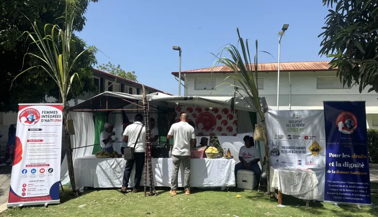 Participants purchase products from FIH vendors during “Let’s Play Together” on Saturday, Aug. 15, 2026, at Lycée Anacaona in Léogâne, Haiti. Photo by Daniella Saint-Louis for The Haitian Times. 
