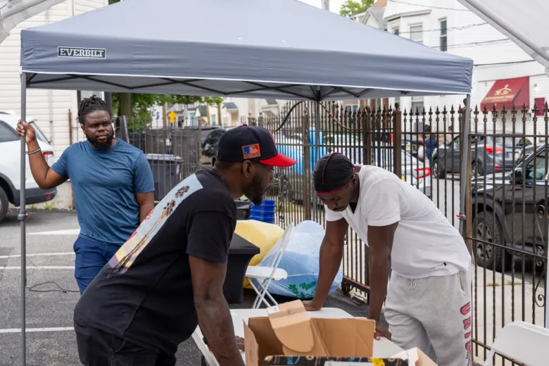 Volunteer Jonas Pierre helps organize setup and supplies at the event at Maranatha Seventh-day Adventist Church in Newark, New Jersey, on Sunday, Aug. 30, 2026. Photo by Fred Cayemitte/The Haitian Times