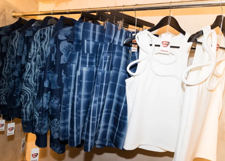 Pieces from Daveed Baptiste’s SS27 collection on display at the SoHo pop-up ft the barber shop shirt in all denim and the bow tank top. Photo by Quadir Ali Moore