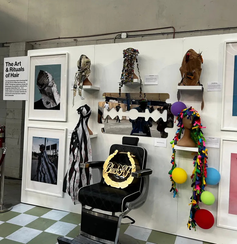 Haitian-American artist Kayra Theodore’s “The Art & Rituals of Hair” exhibition showcases sculptural hairstyles, photography and hair-inspired artwork at CultureCon 2026 at the Brooklyn Navy Yard. Photo by Catherine Roth / The Haitian Times