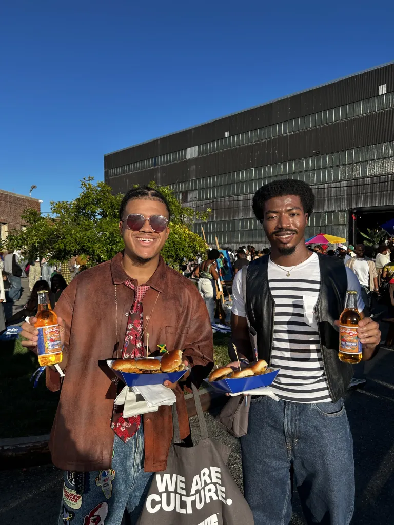 Attendees enjoy food and drinks outside at the Brooklyn Navy Yard during CultureCon 2026. Photo by Catherine Roth / The Haitian Times
